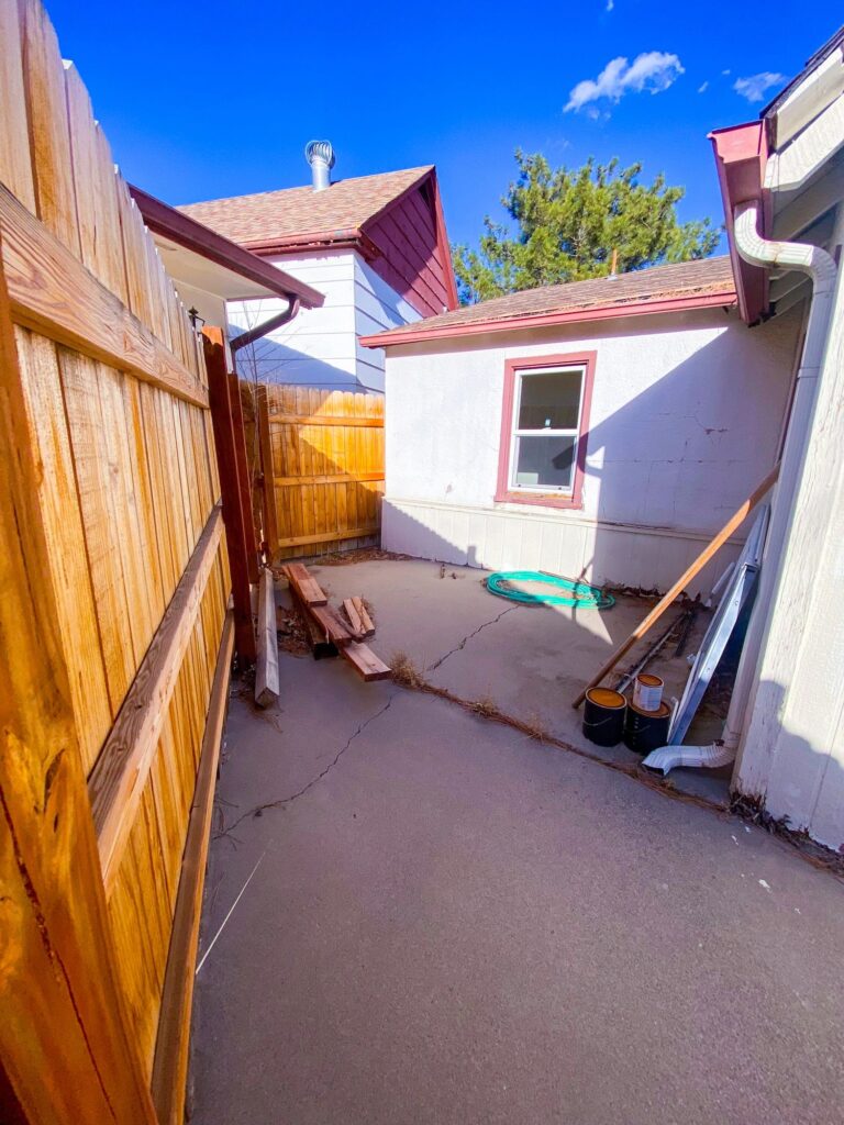 Affordable Housing Rear Courtyard With Fence and Utility Area